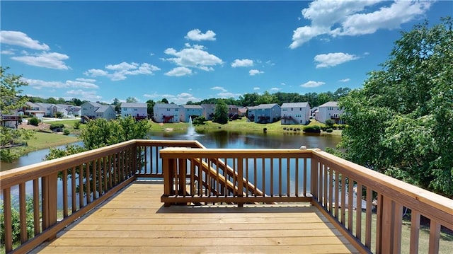 wooden terrace featuring a water view