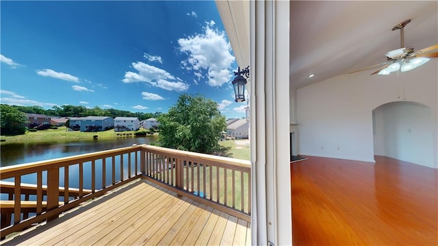 wooden terrace featuring ceiling fan and a water view