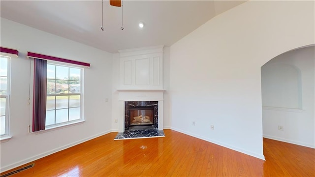 unfurnished living room with hardwood / wood-style flooring and vaulted ceiling