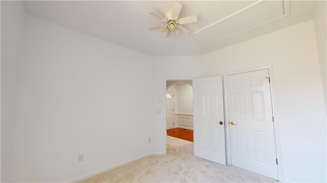 unfurnished bedroom featuring ceiling fan and light carpet