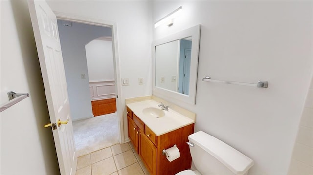 bathroom featuring tile patterned floors, vanity, and toilet