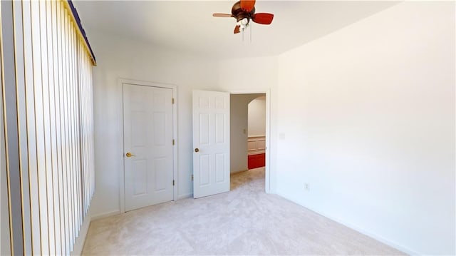 unfurnished bedroom with light carpet and ceiling fan