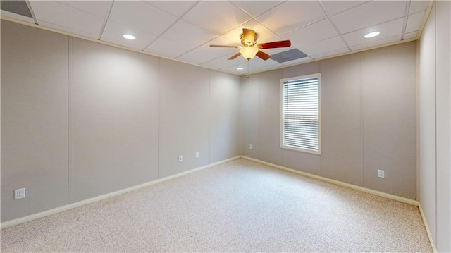 spare room featuring a paneled ceiling, ceiling fan, and carpet floors