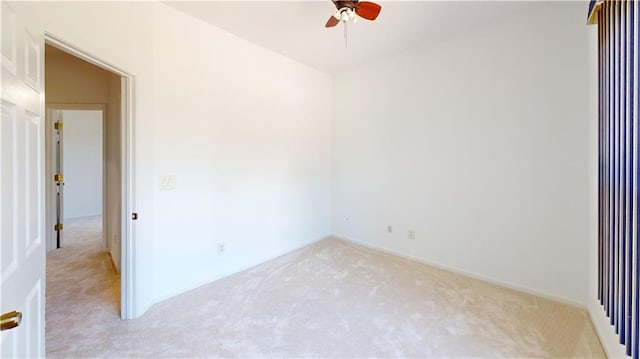 unfurnished room with light colored carpet and ceiling fan