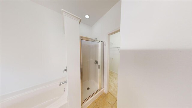 bathroom featuring separate shower and tub and tile patterned flooring