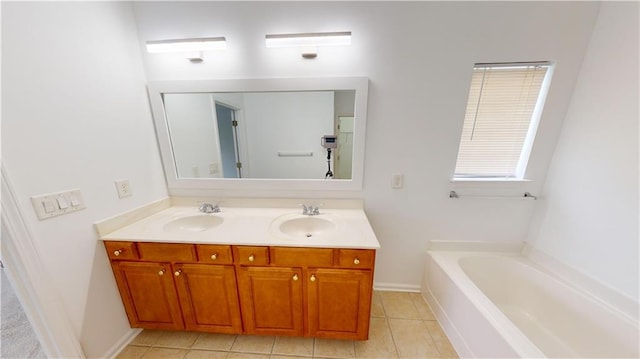 bathroom with tile patterned floors, a bathtub, and vanity