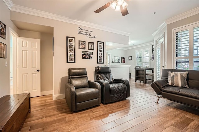 living area with ceiling fan, baseboards, ornamental molding, and light wood-style flooring
