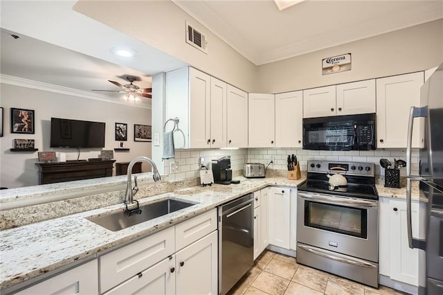 kitchen with crown molding, visible vents, a sink, backsplash, and stainless steel appliances