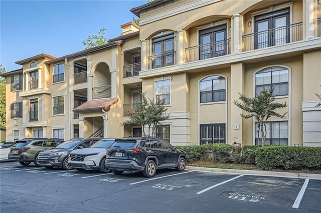 view of building exterior with uncovered parking