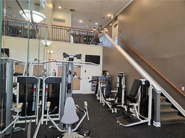 exercise room with recessed lighting, a high ceiling, visible vents, and baseboards