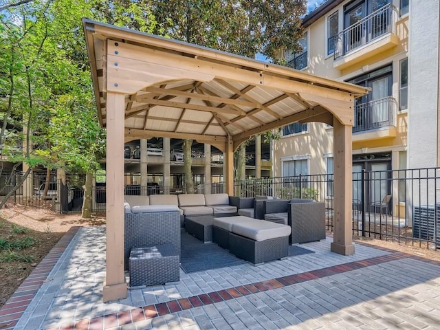 view of patio / terrace featuring fence, a gazebo, and an outdoor living space