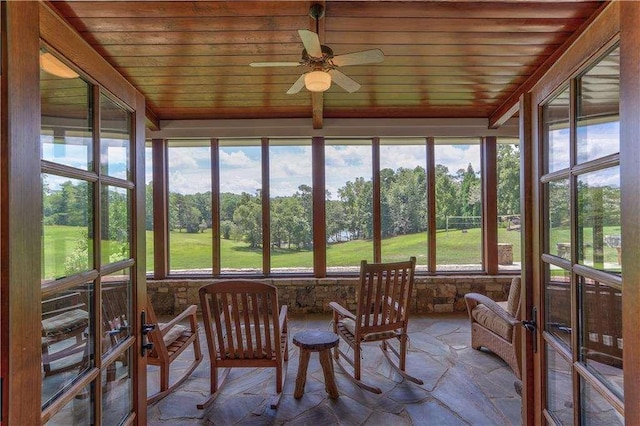 6302 J F Jay Rd, Gainesville, GA 30506 - sunroom featuring wood ceiling, a ceiling fan, view of scattered trees, and stone finish flooring