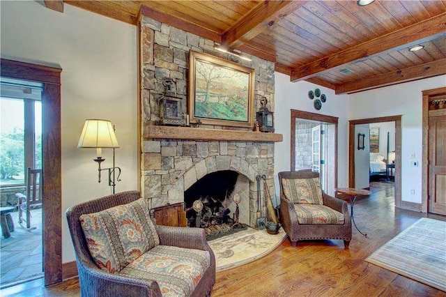 6302 J F Jay Rd, Gainesville, GA 30506 - living room featuring wooden ceiling with exposed beams, a stone fireplace, wood finished floors, and baseboards