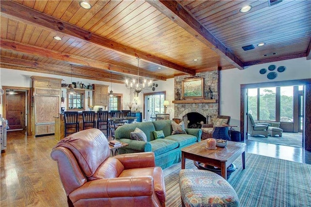 6302 J F Jay Rd, Gainesville, GA 30506 - living room featuring wooden ceiling with exposed beams, light wood-type flooring, a chandelier, a stone fireplace, and recessed lighting