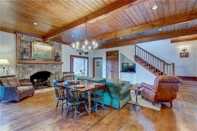 6302 J F Jay Rd, Gainesville, GA 30506 - dining room with a chandelier, a fireplace, wood finished floors, stairway, and wooden ceiling with exposed beams