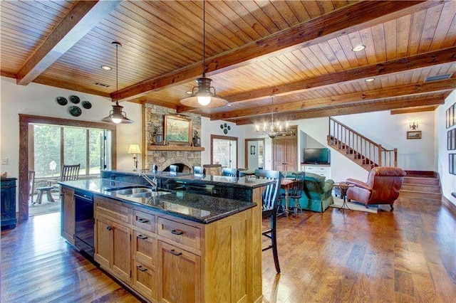 6302 J F Jay Rd, Gainesville, GA 30506 - kitchen with open floor plan, wood ceiling with exposed beams, a sink, a stone fireplace, and a breakfast bar