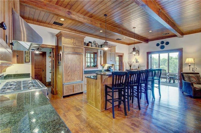6302 J F Jay Rd, Gainesville, GA 30506 - kitchen with ventilation hood, light wood-type flooring, a kitchen breakfast bar, wood ceiling with exposed beams, and pendant lighting