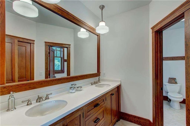 6302 J F Jay Rd, Gainesville, GA 30506 - bathroom featuring toilet, double vanity, and baseboards