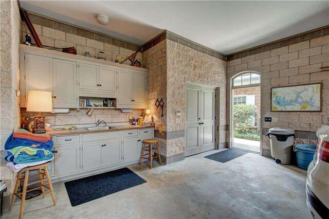 6302 J F Jay Rd, Gainesville, GA 30506 - kitchen featuring a sink, concrete flooring, white cabinets, and open shelves