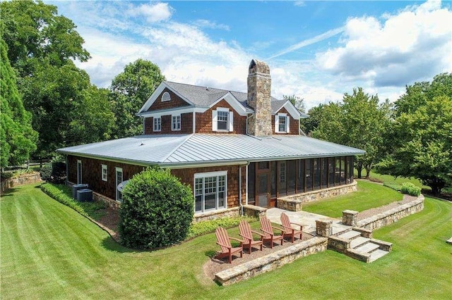 6302 J F Jay Rd, Gainesville, GA 30506 - back of house with a sunroom, a chimney, a standing seam roof, and a lawn