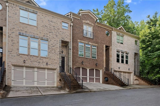 482 Pearl Cove Ct, Atlanta, GA 30350 - view of front of home with stairs, an attached garage, and brick siding
