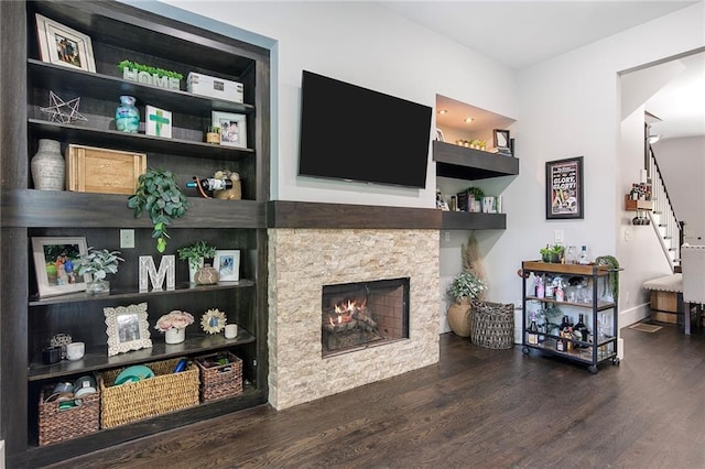 482 Pearl Cove Ct, Atlanta, GA 30350 - living area featuring wood finished floors, stairway, a stone fireplace, built in features, and baseboards