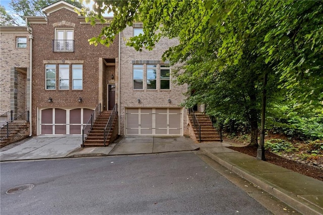 482 Pearl Cove Ct, Atlanta, GA 30350 - view of front of property featuring stairs, driveway, an attached garage, and brick siding