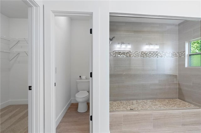 482 Pearl Cove Ct, Atlanta, GA 30350 - bathroom featuring a walk in shower, toilet, a walk in closet, and baseboards
