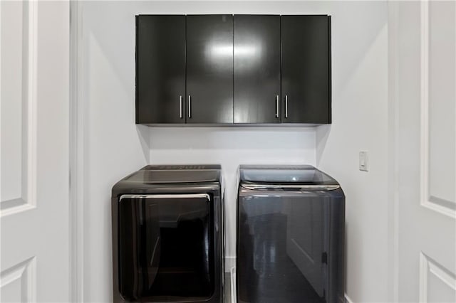 482 Pearl Cove Ct, Atlanta, GA 30350 - laundry room with cabinet space and washing machine and clothes dryer