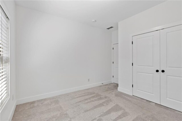 482 Pearl Cove Ct, Atlanta, GA 30350 - unfurnished bedroom with light colored carpet, baseboards, and a closet