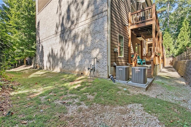 482 Pearl Cove Ct, Atlanta, GA 30350 - view of side of home featuring cooling unit, fence, brick siding, and a wooden deck