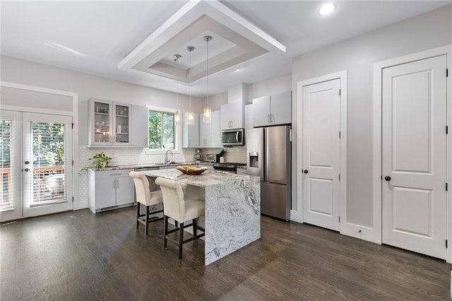 482 Pearl Cove Ct, Atlanta, GA 30350 - kitchen with appliances with stainless steel finishes, dark wood finished floors, backsplash, glass insert cabinets, and recessed lighting