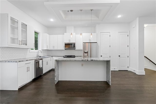 482 Pearl Cove Ct, Atlanta, GA 30350 - kitchen with stainless steel appliances, dark wood-type flooring, a kitchen island, white cabinetry, and glass insert cabinets