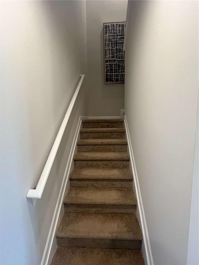 stairway featuring baseboards