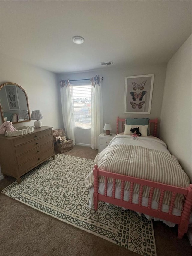 carpeted bedroom featuring visible vents