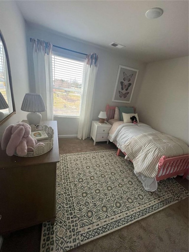 carpeted bedroom featuring visible vents