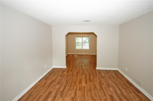 empty room with hardwood / wood-style flooring