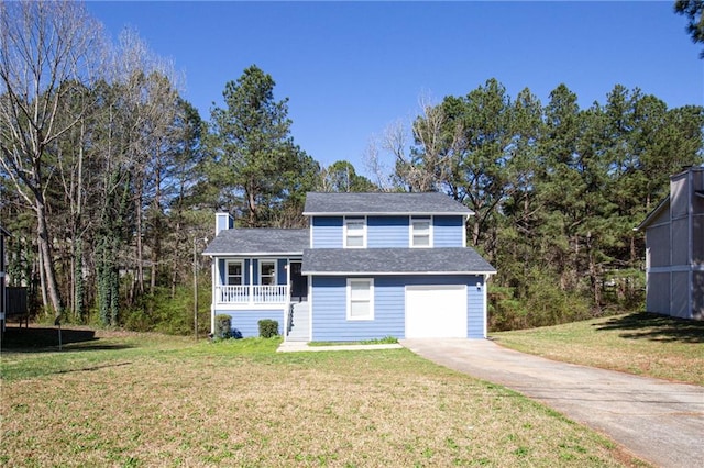 view of front of home with a garage, a porch, a front yard, and a trampoline