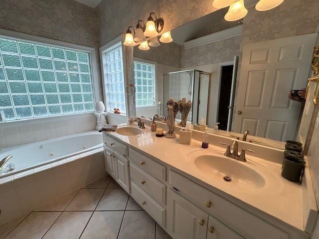 full bathroom with a sink, a whirlpool tub, a stall shower, and a chandelier