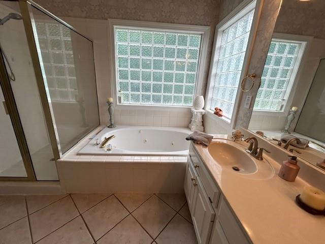 full bath featuring vanity, tile patterned flooring, a shower stall, and a tub with jets