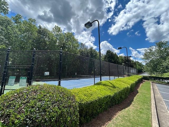 view of sport court with fence