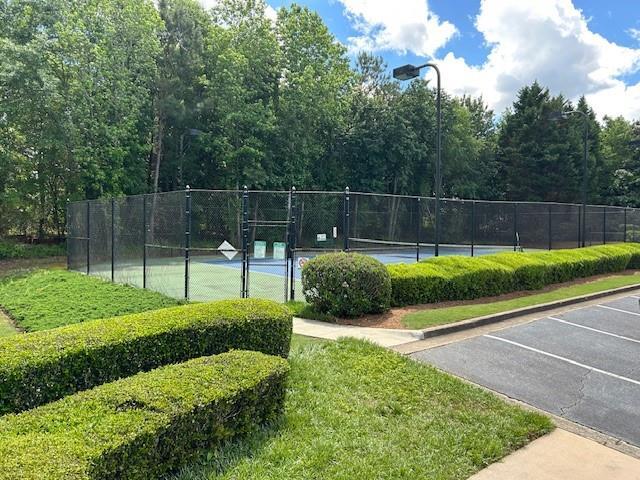 view of tennis court with fence