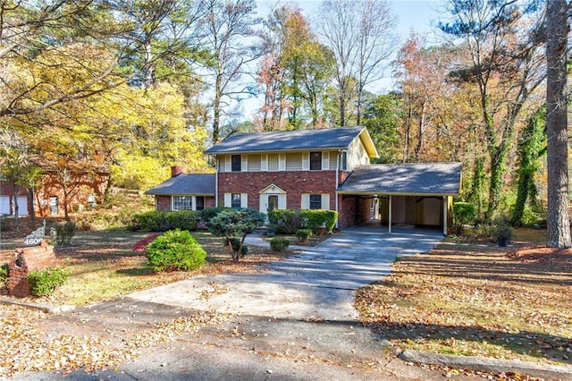 colonial home featuring a carport