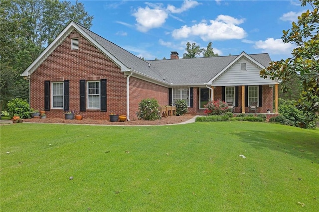 3992 Spot Rd, Cumming, GA 30040 - view of front of house featuring brick siding, a front lawn, covered porch, and a chimney