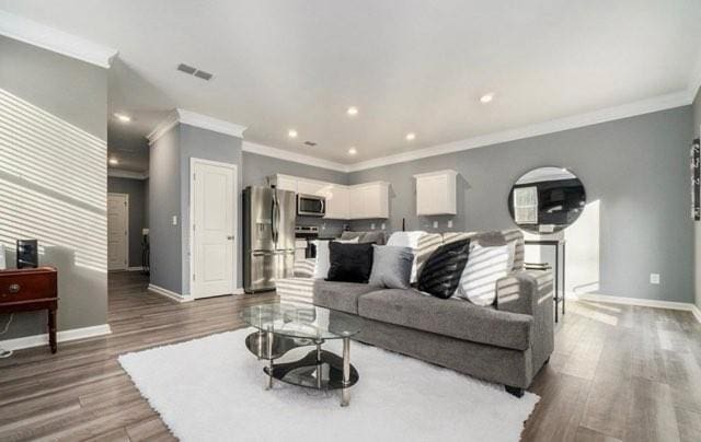 283 Rydal Way, Winder, GA 30680 - living room featuring wood finished floors, crown molding, and recessed lighting