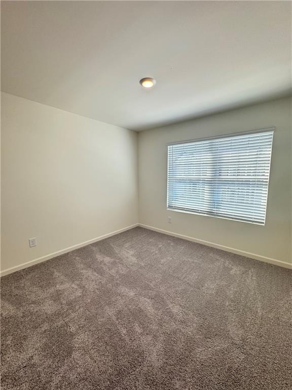 283 Rydal Way, Winder, GA 30680 - empty room featuring dark carpet and baseboards