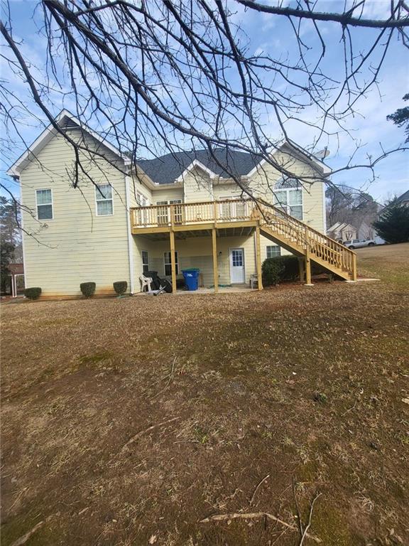 back of property with stairway and a deck