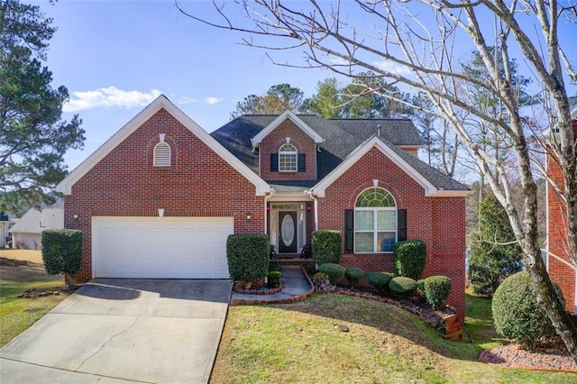 traditional-style home featuring driveway, brick siding, and an attached garage