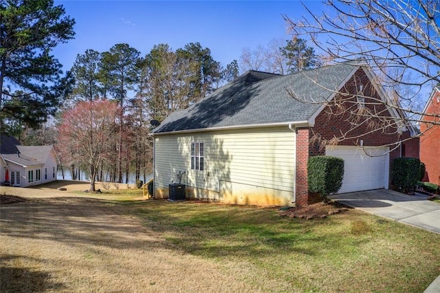 view of home's exterior with brick siding, central air condition unit, a lawn, and driveway