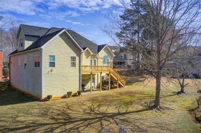 rear view of property with stairway, a patio, a lawn, and a deck